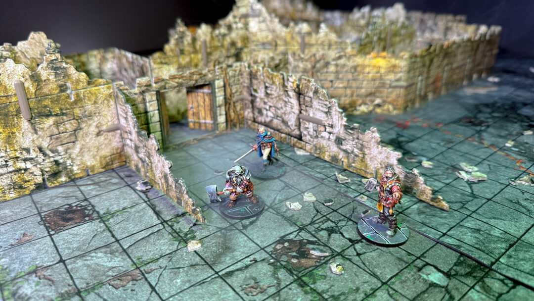 Three adventurers prepare to enter the kobold lair, created using 3D terrain  and inspired by the Cave A of the Caves of Chaos quest from the Heroes of the Borderlands D&D starter set.