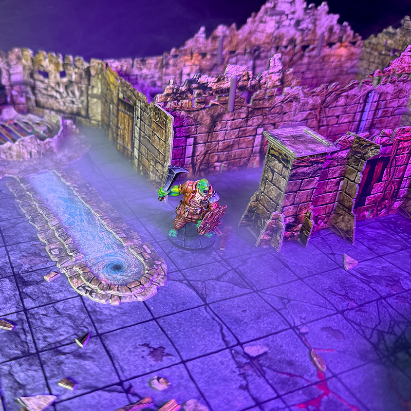 A warrior explores the mephit lair, created using 3D terrain and inspired by the Cave B of the Caves of Chaos quest from the Heroes of the Borderlands D&D starter set.