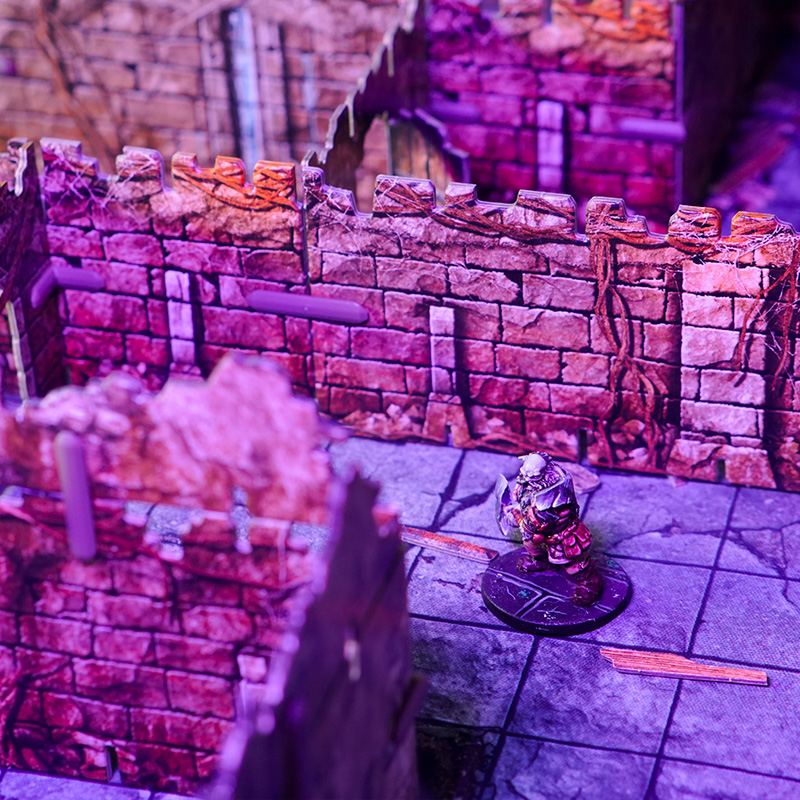 A warrior explores the mephit lair, created using 3D terrain and inspired by the Cave B of the Caves of Chaos quest from the Heroes of the Borderlands D&D starter set.